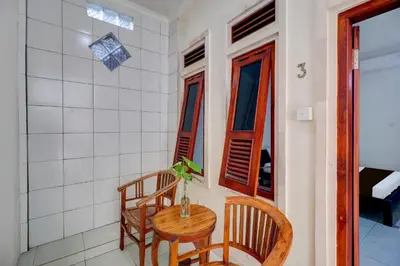a small table and two chairs in a room at Collection O Budget Door Legian Inn @Poppies Road in Legian
