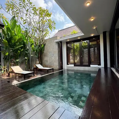 a swimming pool in the middle of a house at Tolgay Living Villas in Seminyak