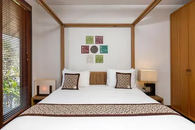 a bedroom with a large bed and a window at Tolgay Living Villas in Seminyak