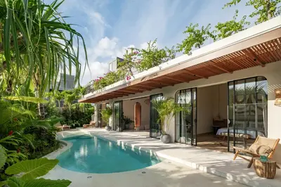 a swimming pool in the backyard of a house at New SASS Villa - Stylish & Modern 3BR at Seminyak in Seminyak