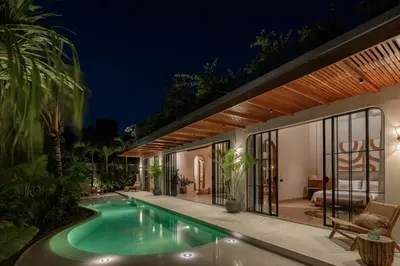 a house with a swimming pool at night at New SASS Villa - Stylish & Modern 3BR at Seminyak in Seminyak