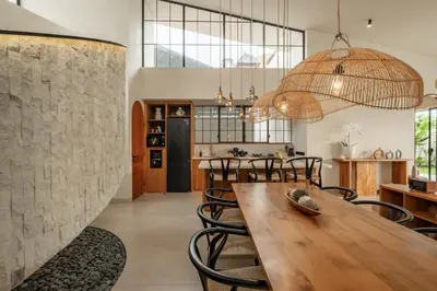 a kitchen and dining room with a wooden table and chairs at New SASS Villa - Stylish & Modern 3BR at Seminyak in Seminyak