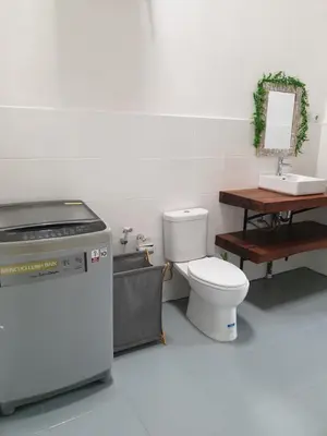 a bathroom with a toilet and a sink at Vina villa in Kerobokan