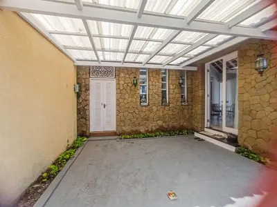 a patio with a white door and a stone wall at villa Bunga in Seminyak