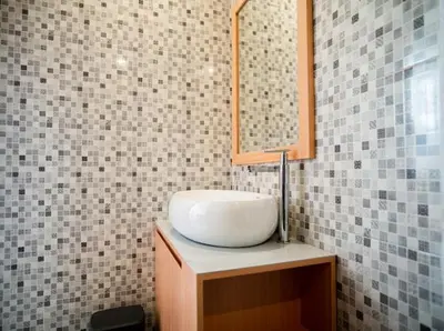a bathroom with a sink and a mirror at Aspen bali nusa dua in Nusa Dua