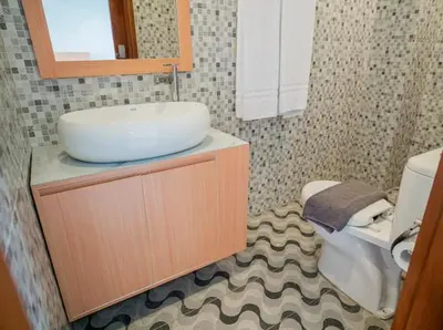 a bathroom with a sink and a toilet at Aspen bali nusa dua in Nusa Dua
