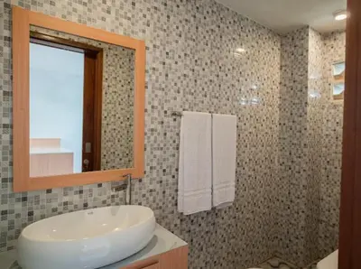 a bathroom with a sink and a mirror at Aspen bali nusa dua in Nusa Dua