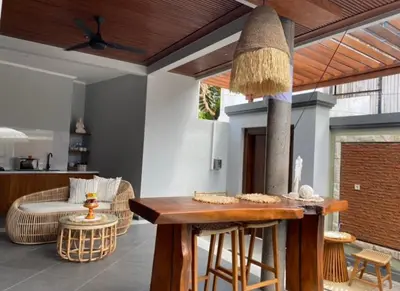 a kitchen and living room with a table and chairs at Villa Sooni 1 in Seminyak