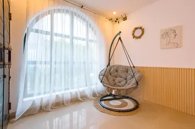 a swing in a room with a window at Casa Yo-Na Seminyak in Seminyak