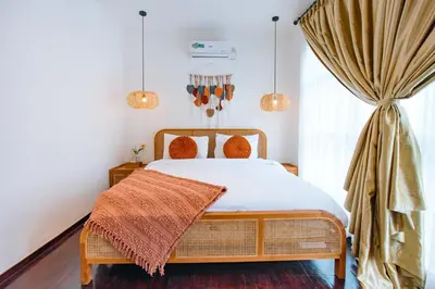 a bedroom with a bed and a window at Casa Yo-Na Seminyak in Seminyak