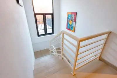 a staircase in a home with white walls at Casa Yo-Na Seminyak in Seminyak