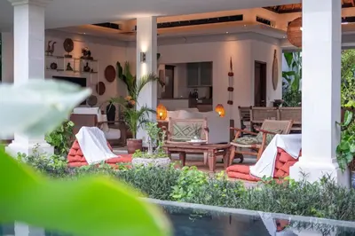 a patio with chairs and a table on a house at Spacious Charming 4BR Balinese Villa, Seminyak in Kerobokan
