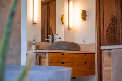 a bathroom with a sink and a mirror at Spacious Charming 4BR Balinese Villa, Seminyak in Kerobokan
