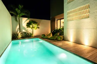 a swimming pool in a house with plants in it at Hanupis Canggu Apartment in Canggu