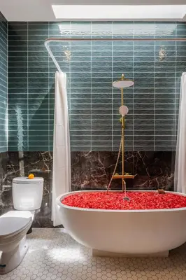 a bathroom with a bath tub with a toilet at Modern and Petite 2bd Seminyak Villa Construction Near in Seminyak