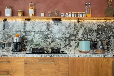 a kitchen with a counter with a stove top oven at Modern and Petite 2bd Seminyak Villa Construction Near in Seminyak
