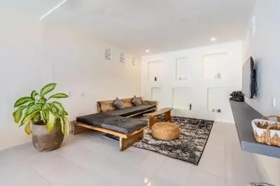 a living room with a couch and a potted plant at Villa Durna 2 in Seminyak