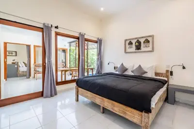 a bedroom with a bed and a balcony at Villa Durna 2 in Seminyak