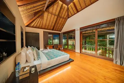 a bedroom with a bed in a room at Villa Ramadewa Beachside with Authentic Charm in Seminyak
