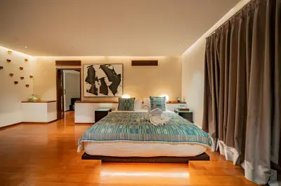 a bedroom with a large bed in a room at Villa Ramadewa Beachside with Authentic Charm in Seminyak
