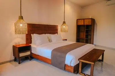 a bedroom with a large bed and a table at Villa Sinergi Seminyak 7 in Seminyak