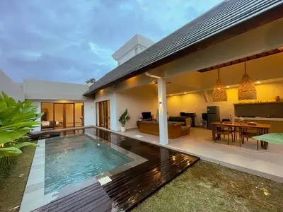 a house with a swimming pool in the backyard at Villa Sinergi Seminyak 7 in Seminyak