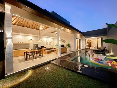 a house with a swimming pool in the yard at Villa Sinergi Seminyak 8 in Seminyak