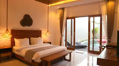 a bedroom with a bed and a sliding glass door at Villa Sinergi Seminyak 8 in Seminyak