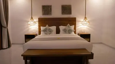 a bedroom with a large bed with two night stands at Villa Sinergi Seminyak 8 in Seminyak