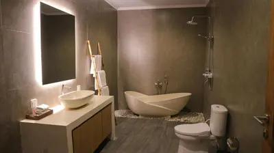 a bathroom with a tub and a sink and a toilet at Villa Sinergi Seminyak 8 in Seminyak
