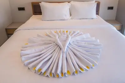 a white bed with a heart made out of towels at Villa Baile Bali by Great Bali Villas in Jimbaran