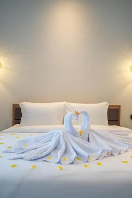 two swans made out of towels on a bed at Villa Baile Bali by Great Bali Villas in Jimbaran