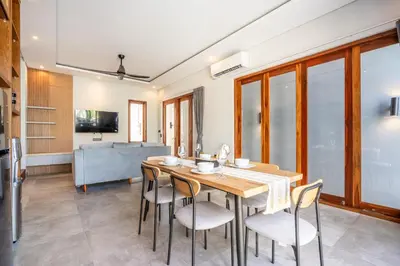 a kitchen and dining room with a wooden table and chairs at Villa Baile Bali by Great Bali Villas in Jimbaran