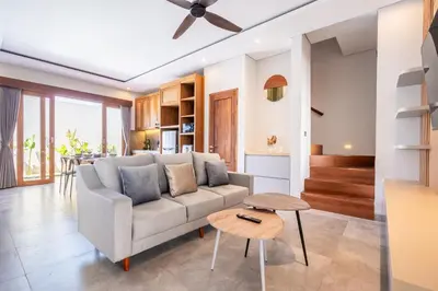 a living room with a couch and a table at Villa Baile Bali by Great Bali Villas in Jimbaran