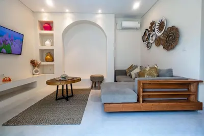 a living room with a couch and a table at Villa Amaia Bali in Kerobokan