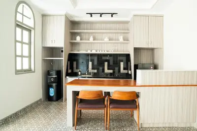 a kitchen with a counter and two chairs at Villa Mentari at Umalas in Kerobokan