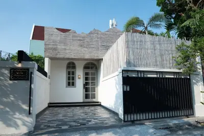 a white house with a gate and a fence at Villa Mentari at Umalas in Kerobokan