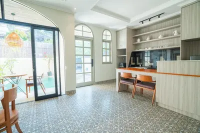 a kitchen with a counter and a table with chairs at Villa Mentari at Umalas in Kerobokan
