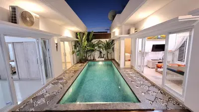 a swimming pool in the middle of a house at Villa GOwen in Jimbaran