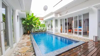 a swimming pool in the middle of a house at Villa GOwen in Jimbaran