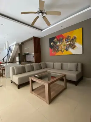 a living room with a couch and a coffee table at Vila Samatha 2 Nusa Dua in Nusa Dua