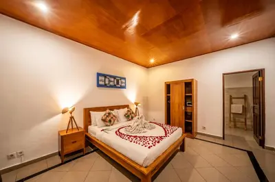 a bedroom with a bed with a wooden ceiling at Villa Kusuma 1 Seminyak in Seminyak