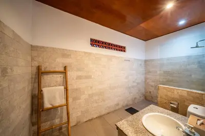 a bathroom with a sink and a wooden ceiling at Villa Kusuma 1 Seminyak in Seminyak