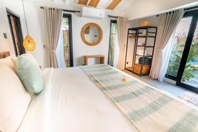 a bedroom with a large white bed and windows at Villa Mint, 3Br Tropical Escape, Near Bintang Supermarket in Seminyak