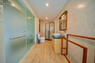 a bathroom with a shower and a sink and a toilet at Villa Cahaya Berlian in Kerobokan