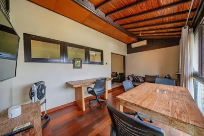 a living room with a wooden table and chairs at Villa Cahaya Berlian in Kerobokan