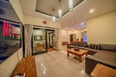 a living room with a couch and a table at Villa Cahaya Berlian in Kerobokan
