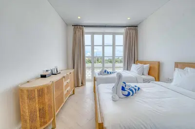 a bedroom with two beds and a window at Villa Isabella 4BR Brand New in Berawa, Canggu in Canggu