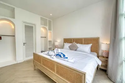 a bedroom with a large bed with towels on it at Villa Isabella 4BR Brand New in Berawa, Canggu in Canggu