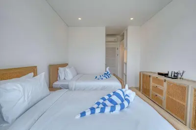 a bedroom with two beds and a desk at Villa Isabella 4BR Brand New in Berawa, Canggu in Canggu